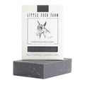 Little Seed Farm’s Activated Charcoal Facial & Body Bar, handmade in Tennessee with organic oils, is perfect for acne-prone skin and detoxifying care. Features goat-themed packaging and a sleek dark gray finish.