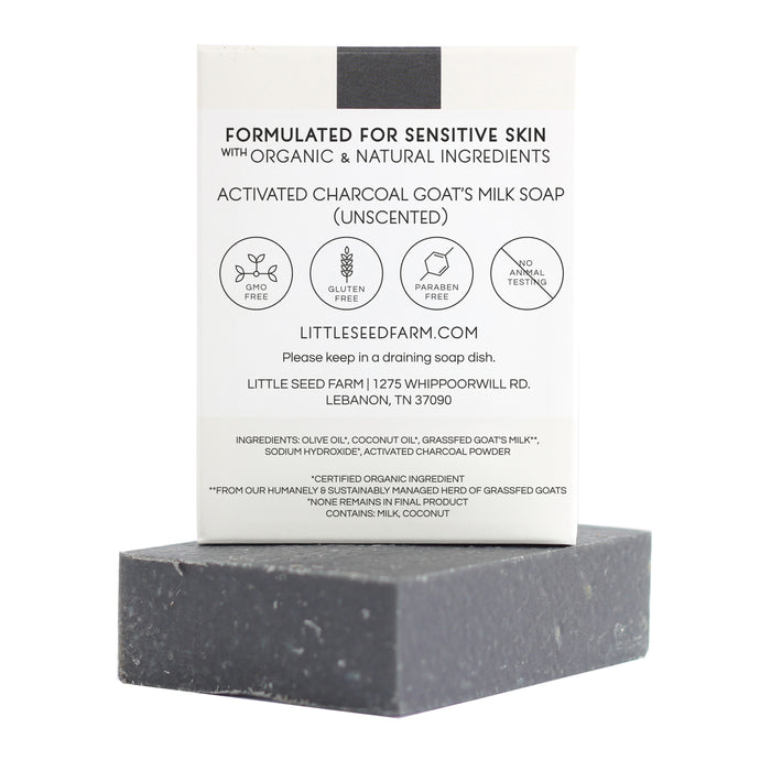 The Activated Charcoal Facial & Body Bar from Little Seed Farm is an unscented black soap made with organic, natural ingredients, designed for sensitive and acne-prone skin. It sits in front of its branded box.