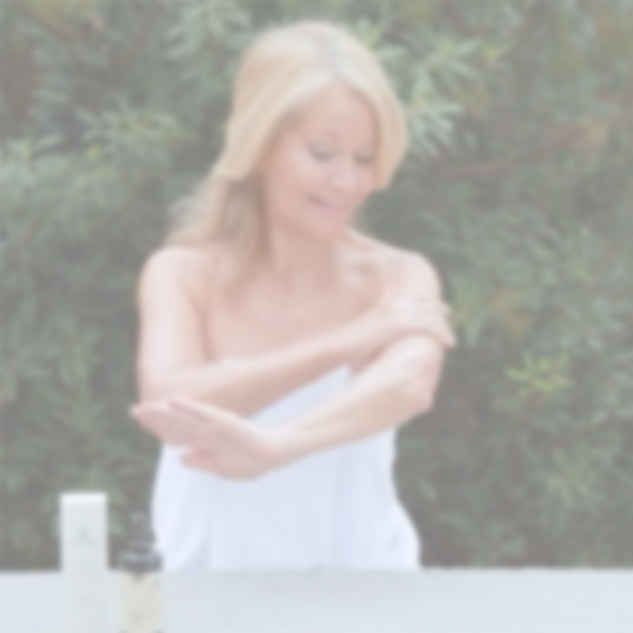 Woman applying Annmarie Radiant Skin Silk Body Lotion as part of a daily body care routine