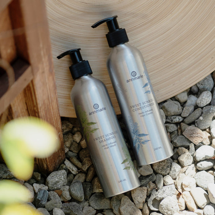 Annmarie Sweet Sunrise Conditioner displayed with natural botanicals and hair care products