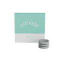 Aroma Stone 3-Pack by Canopy featuring three gray circular diffuser stones displayed beside mint green and white product packaging for essential oil aromatherapy use