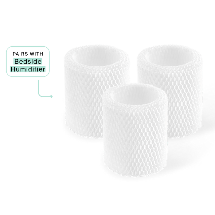 Three white cylindrical Bedside Humidifier Filters with mesh-like texture arranged in a group, showing their antimicrobial design. A small label indicates compatibility with Bedside Humidifier model.