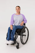 Woman in wheelchair wearing purple Raglan Access Tee