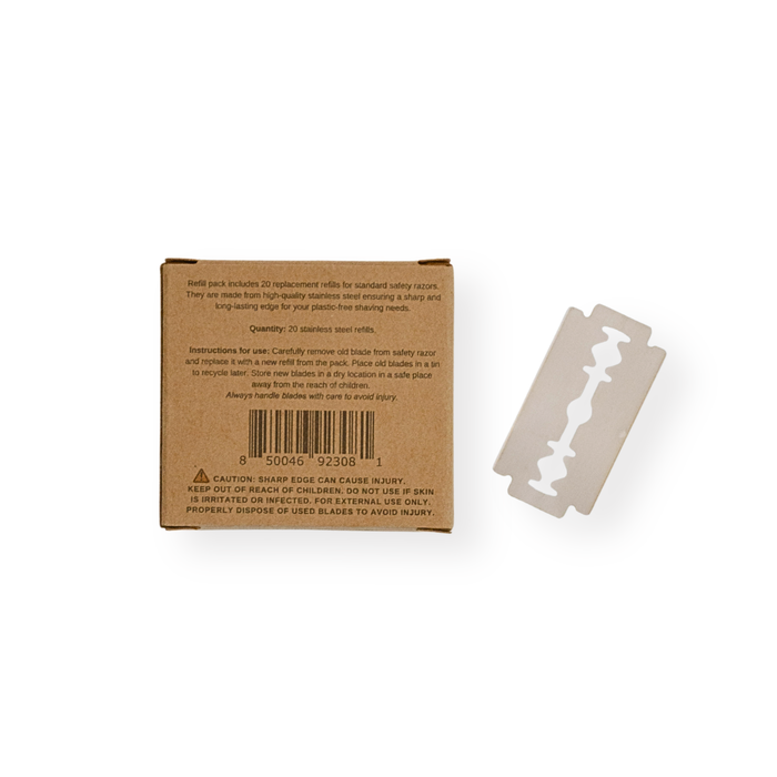 A Me Mother Earth Safety Razor Refill Pack in a brown cardboard box with instructions and barcode is shown next to a single stainless steel replacement blade on a white background.