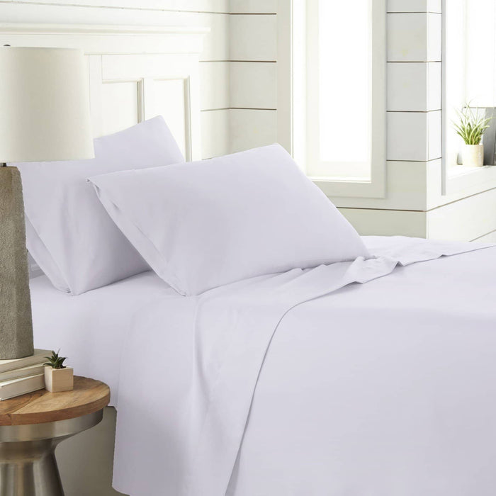 Angled view of Southshore Essentials 4-piece sheet set showcasing smooth bright-white fabric and fitted sheet on a made bed in a sunlit bedroom