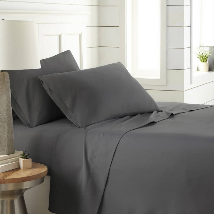 Angled view of Southshore Essentials 4 piece sheet set in slate showing ultra soft fabric on a bed with white headboard