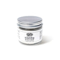 A small clear glass jar of Anima Mundi TOOTH POLISH, Fluoride Free, Net Wt. 2.5 oz / 71 g, with a silver lid on a white background, featuring a plant-based clay formula for naturally brighter smiles.